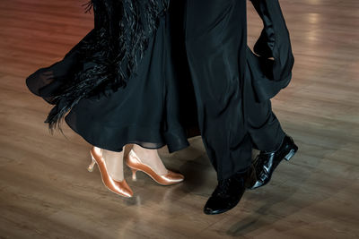 Low section of woman standing on hardwood floor