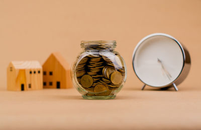 Close-up of coins in jar on table