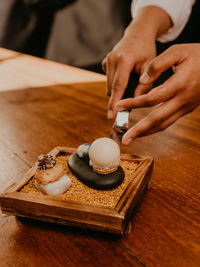 Midsection of man preparing food on table