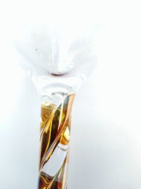 Close-up of glass bottle against white background