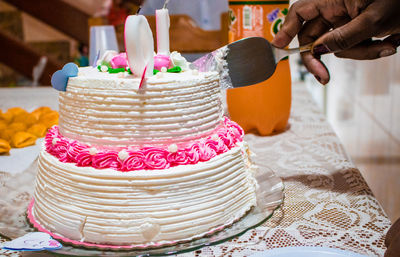 Midsection of person holding cake