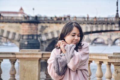 Young woman standing in park during winter