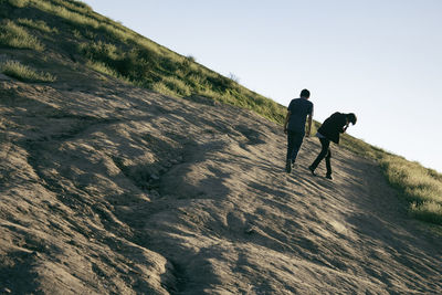 Low angle view of man standing on mountain