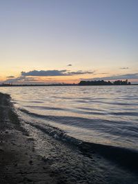 Scenic view of beach against sky during sunset