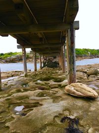 Interior of bridge over river against sky