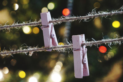 Close-up of clothespins hanging on rope