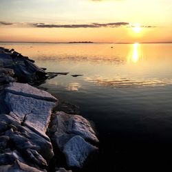 Scenic view of sea against sky at sunset