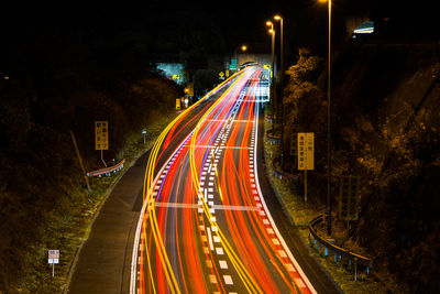 High angle view of light trails on road at night