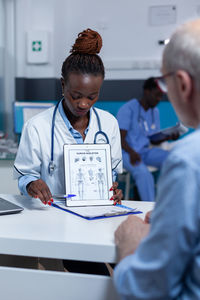 Doctor showing digital tablet do patient