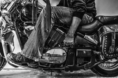 Low section of man sitting on motorcycle