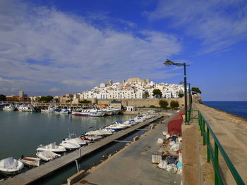 View of town by sea against sky