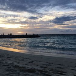 Scenic view of beach against sky during sunset