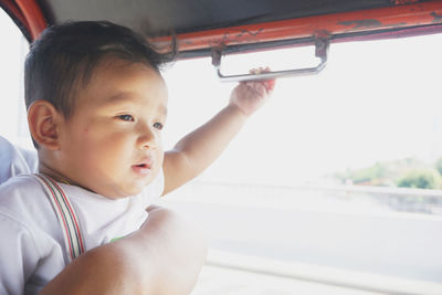 Close-up of cute baby boy in bus