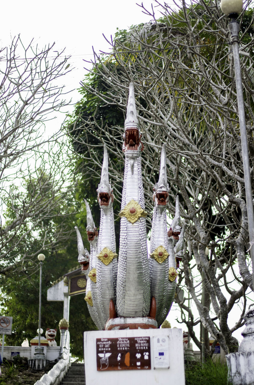 VIEW OF STATUE AGAINST TREES