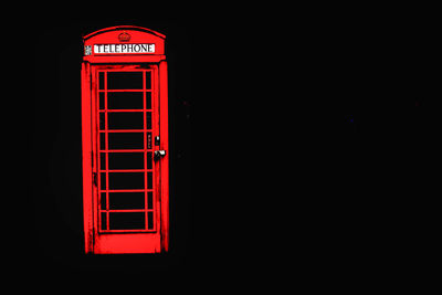 Illuminated text on red light against black background