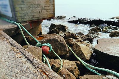 Close-up of rope tied to sea