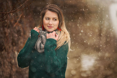 Portrait of a smiling young woman in snow