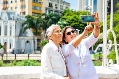 Senior mother and daugther travelling togeher having fun. senior adults in cali colombia. 