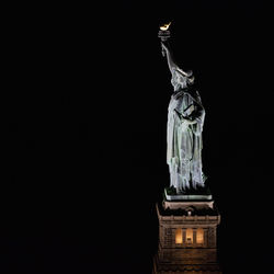 Low angle view of statue against sky at night