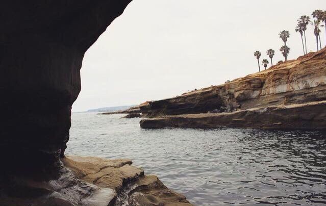 sea, water, tranquil scene, tranquility, horizon over water, clear sky, beach, scenics, rock - object, beauty in nature, rock formation, nature, shore, sky, copy space, cliff, idyllic, rock, vacations