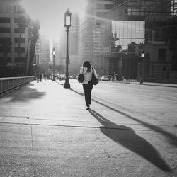 Full length of man skateboarding on city