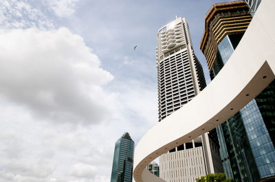 Low angle view of buildings against cloudy sky