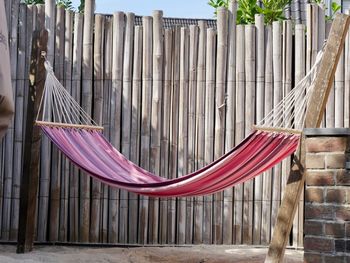 Hammock in front of bamboo fence