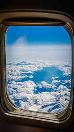 Aerial view of sea seen through airplane window