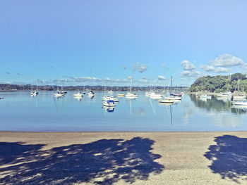 Boats moored in calm blue sea