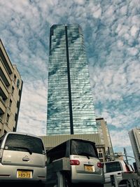 Low angle view of building against cloudy sky