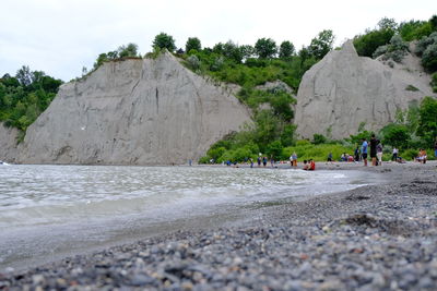 Surface level of rocks on beach against sky