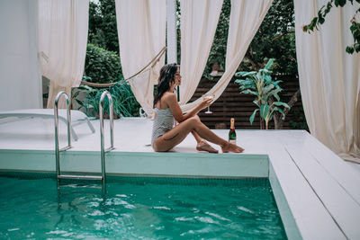 Woman relaxing in swimming pool