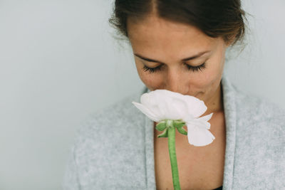 Woman smelling flower