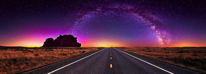 Road against sky at night