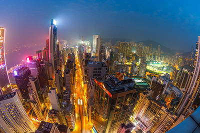 High angle view of illuminated city buildings at night