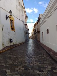 Empty alley amidst buildings in city