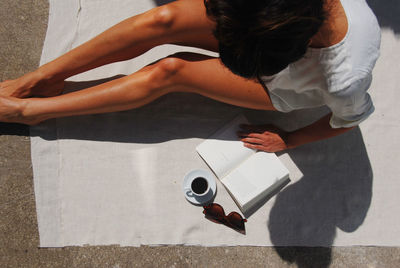 High angle view of woman holding coffee cup