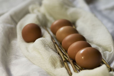High angle view of eggs in container on bed