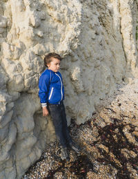 Full length of boy standing on rock