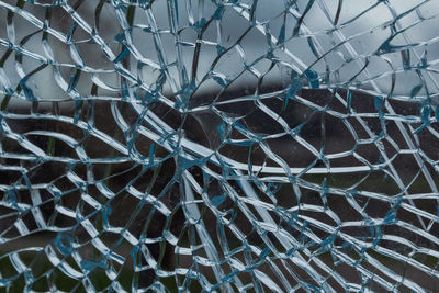 Full frame shot of blue broken glass window