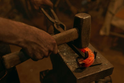 Close-up of man working on metal