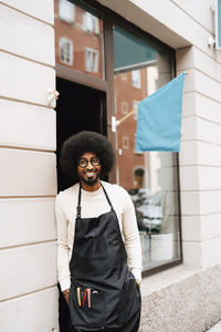 Portrait of smiling male barber outside hair salon