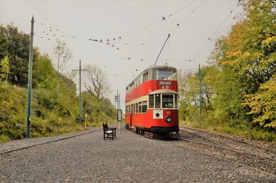 Tramp on railroad track against sky