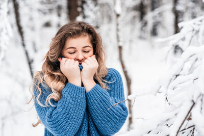 Young woman smiling in snow