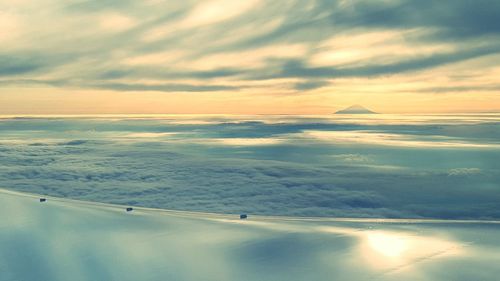 Scenic view of mountains against cloudy sky