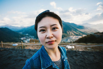 Portrait of woman standing against mountains