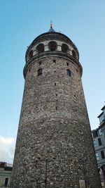 Low angle view of old building against blue sky