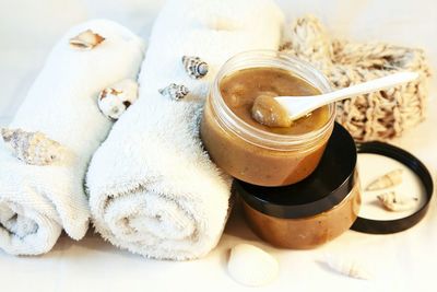 High angle view of rolled towels and beauty products on table