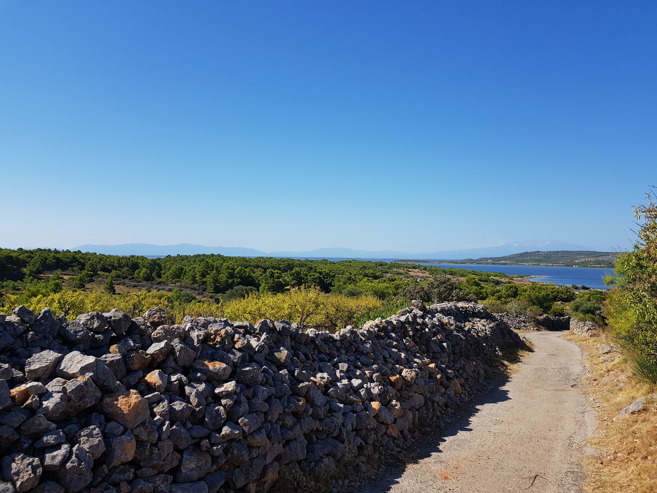 PANORAMIC VIEW OF ROCKS AGAINST CLEAR BLUE SKY