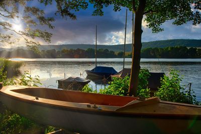 Boats moored in lake against sky